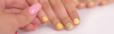 Little girl getting a colourful manicure